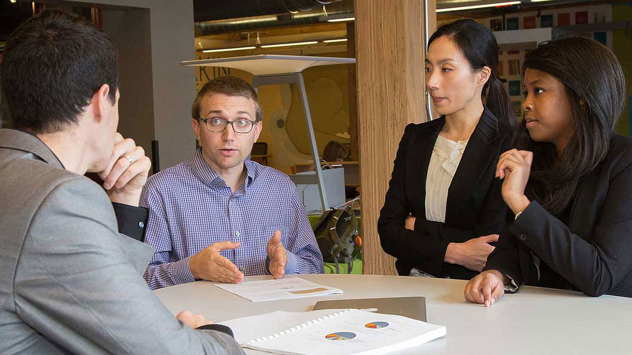 CEL team consults with client in TRex office space