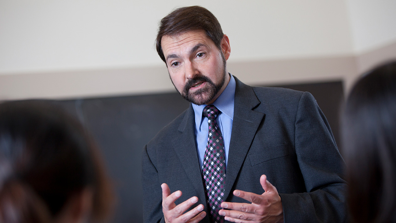 Professor lecturing students about supply chain management for the Olin school of business