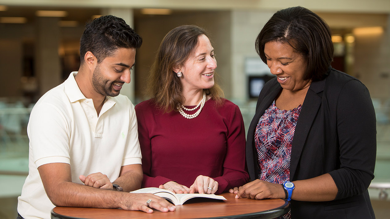 Students and faculty discussing the PhD in Organizational Behavior program with Olin School of Business