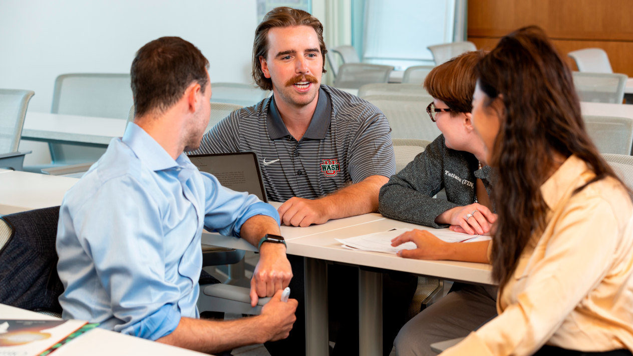 Students working together in a classroom as part of the PhD in Entrepreneurship program with Olin School of Business