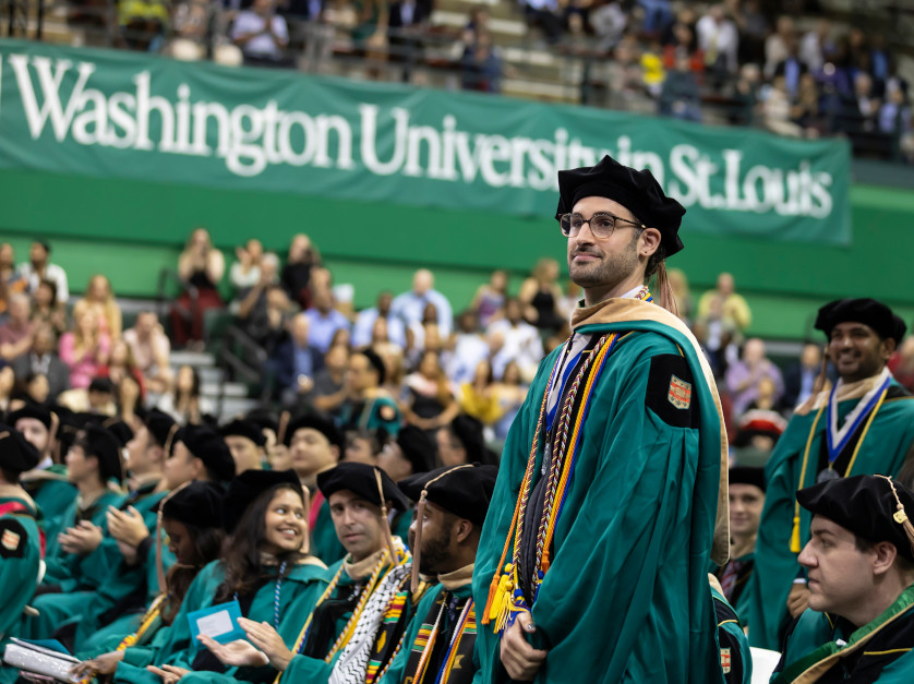 graduate man standing during ceremony