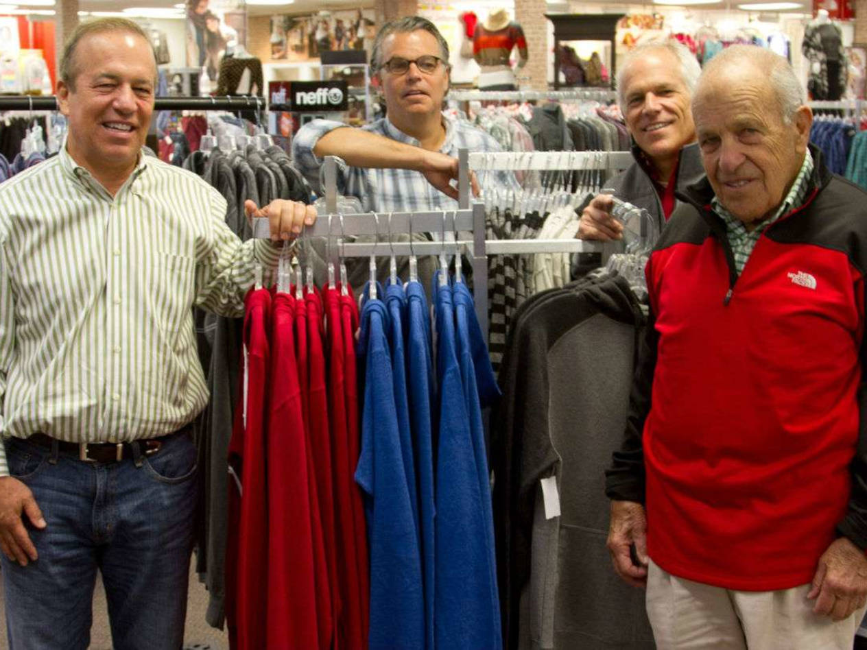 Joe Glik, right, with sons Robert, Jeffrey, and James, at a Glik’s store in Farmington, Mo., Photo courtesy of the Farmington Chamber of Commerce.