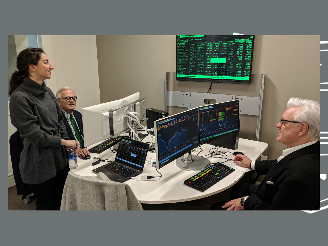 Timothy Solberg working on a terminal along with Dean Mark Taylor under the guidance of Bianca Simonetti, Bloomberg’s account manager for the St. Louis area.
