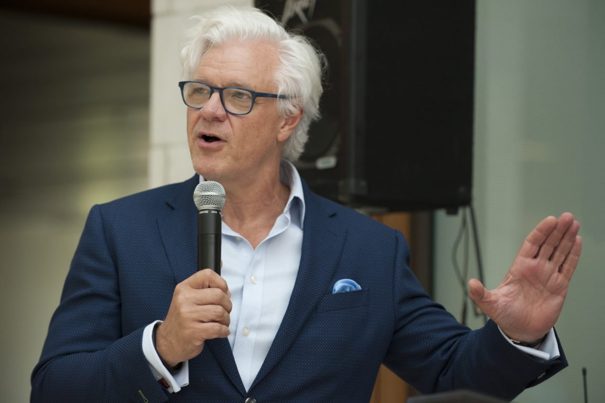 Dean Mark Taylor speaks at an ice cream social event