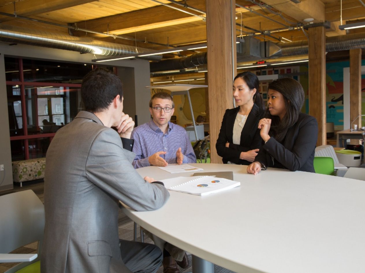 A student team from the CEL meets to discuss a project (photographed before the pandemic).