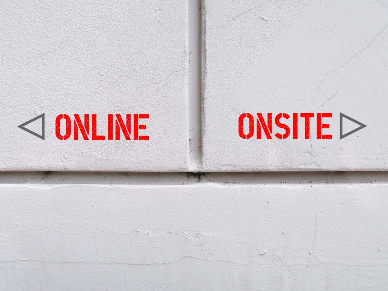 a picture of words on a wall: 'Online' and 'Onsite' with arrows pointing in opposite directions