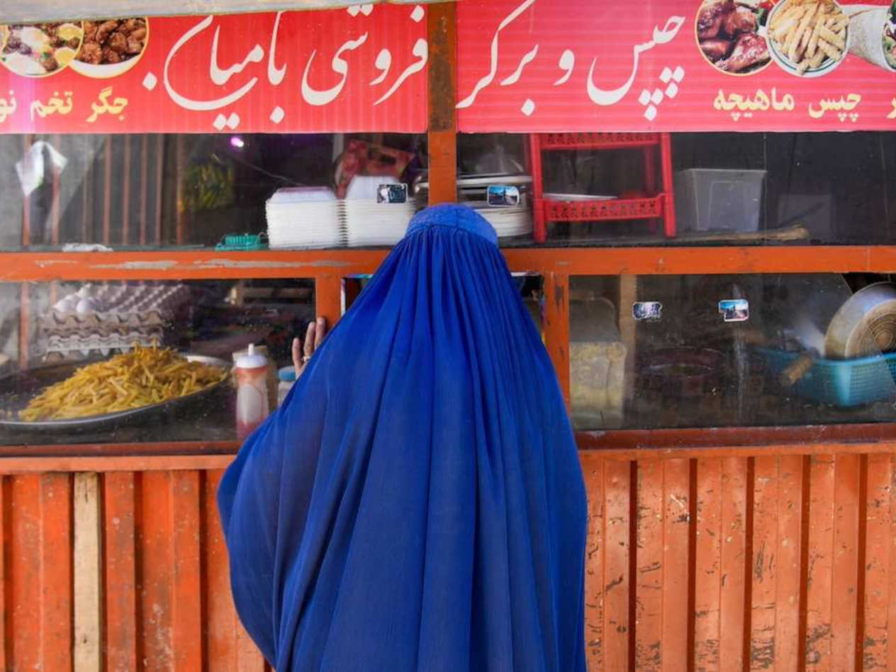 A woman buying food in Afghanistan
