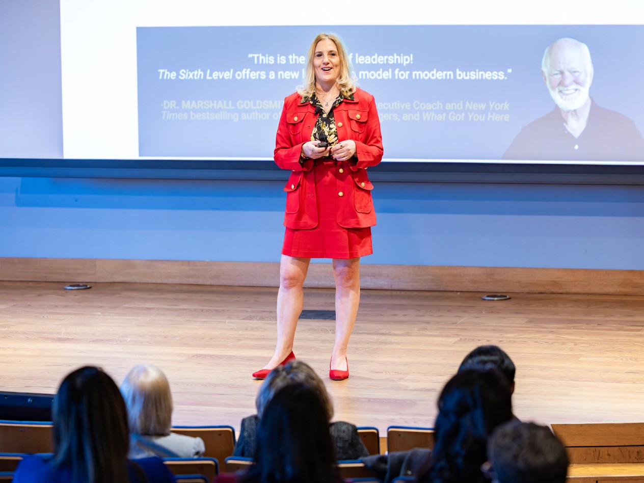 Rachel Wallis Andreasson stands on a stage in front of a crowd