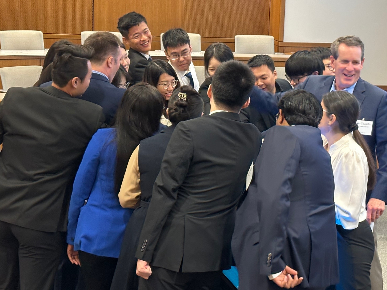 Students in suits compete at a symposium