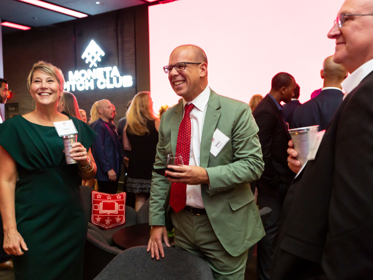 Olin Dean Mike Mazzeo celebrates with EMBA alumni