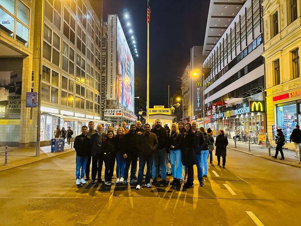 A group of students standing on a street at night