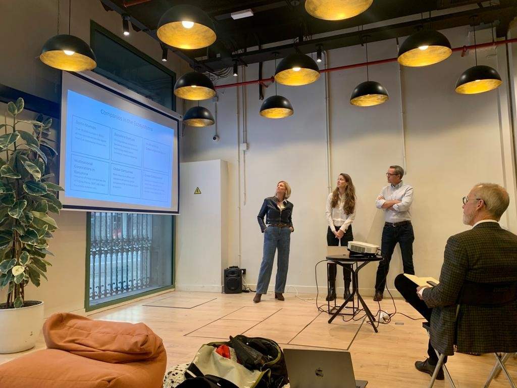 Students giving a presentation using a large screen