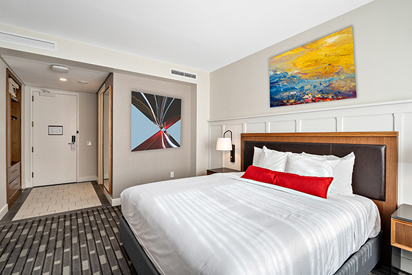 A hotel room with one king-sized bed