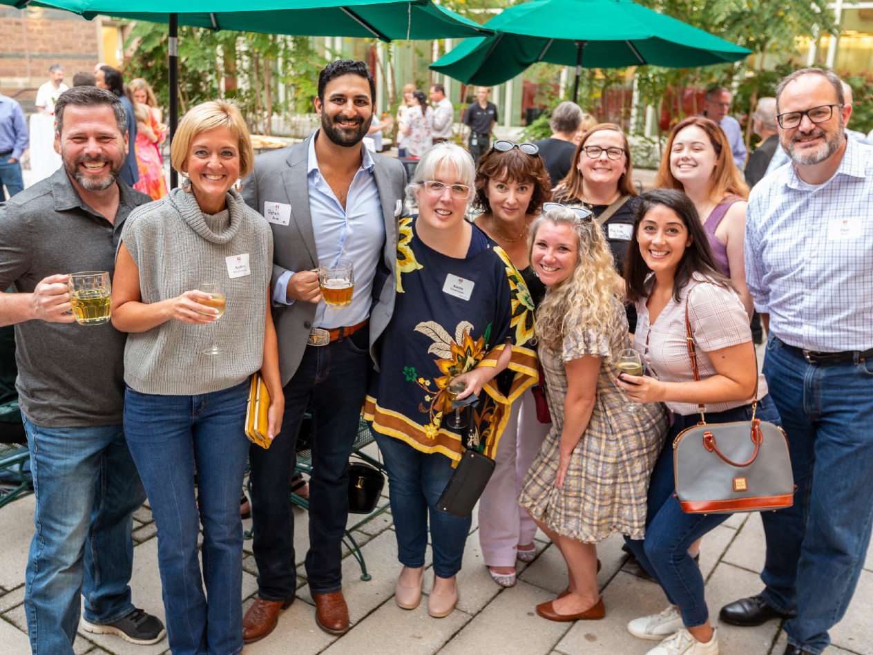 A group of Olin alumni smiling for the camera.