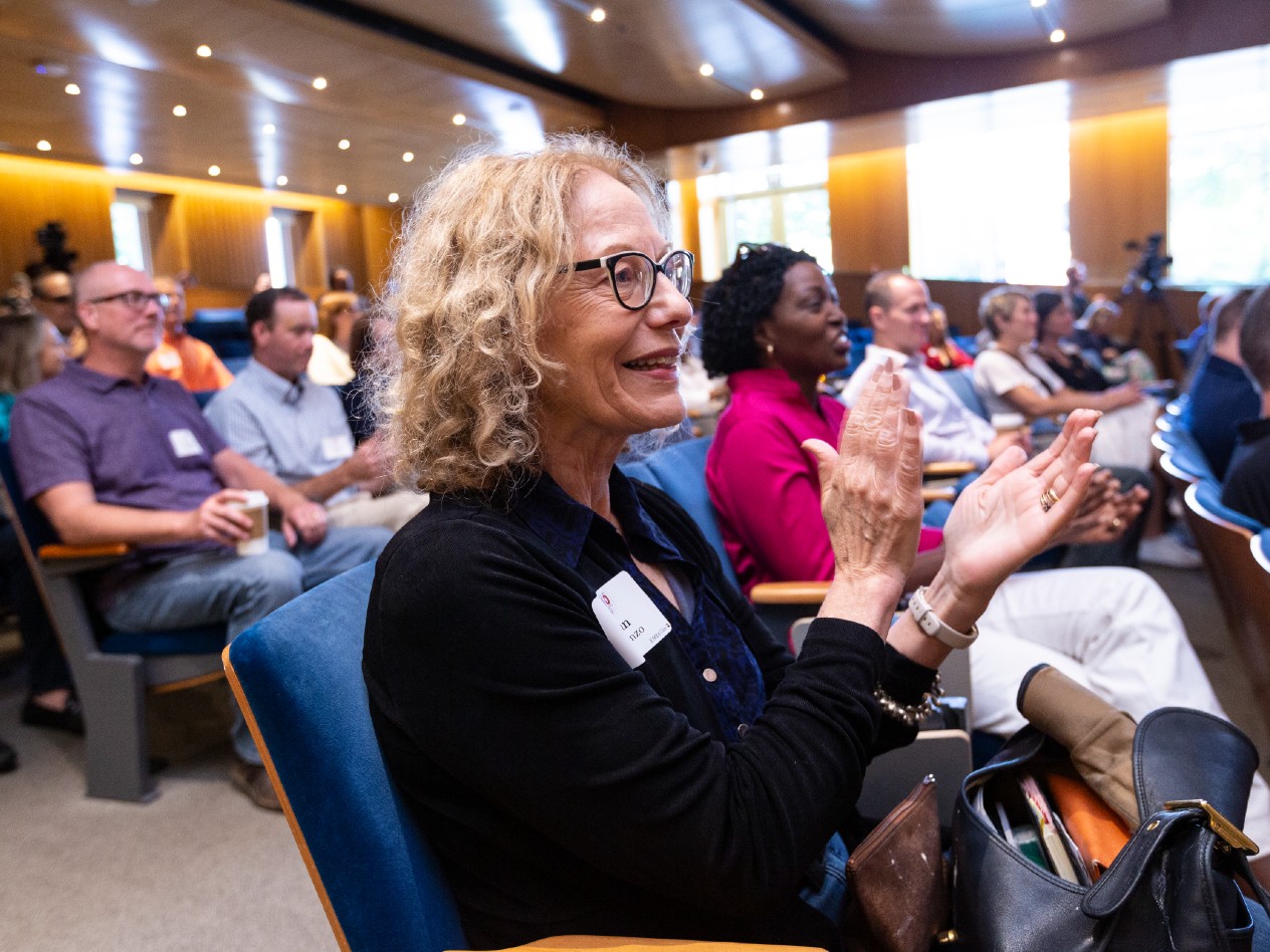 An audience applauds during a presentation in Emerson Auditorium.