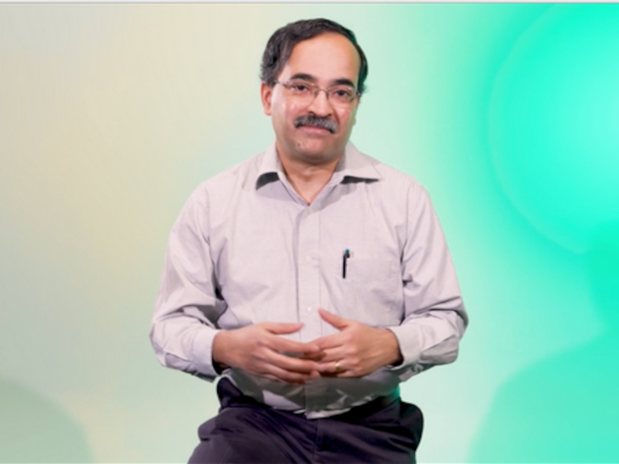 Seethu Seetharaman records a class in front of a CDE green screen.