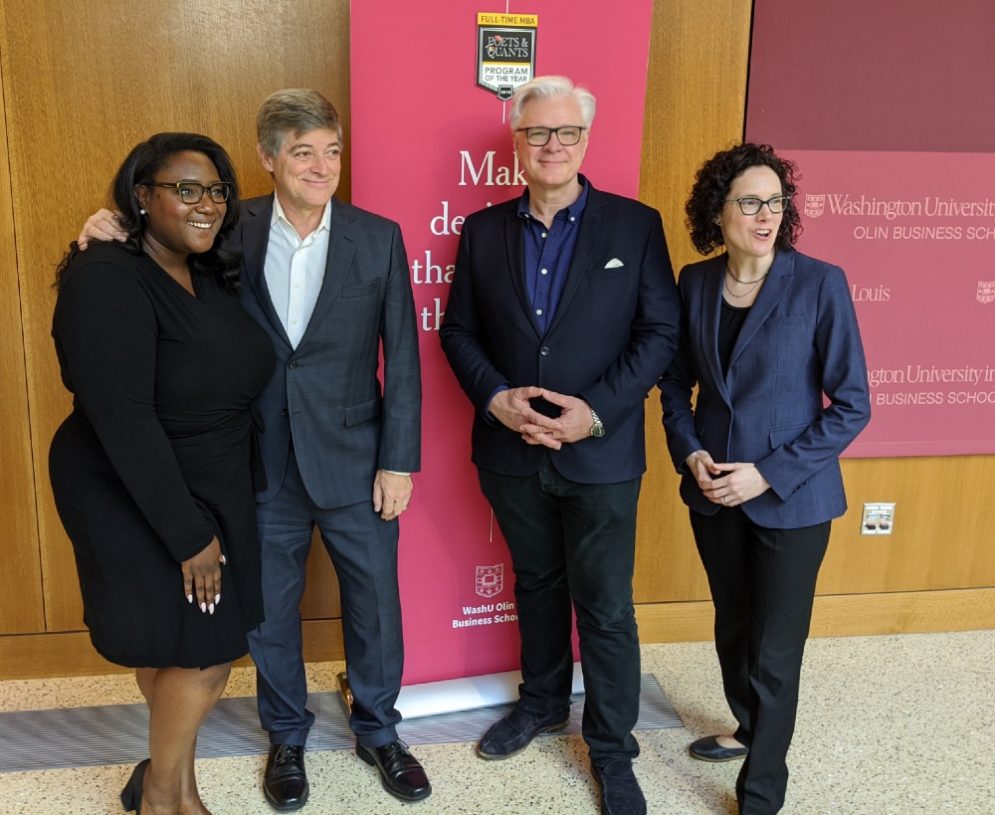 First-year MBA students Kendra Kelly and Jennifer Lanas flank John Byrne and Dean Mark Taylor at the “program of the year” party.