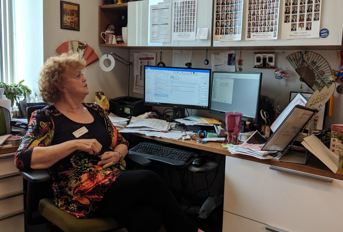 Jan Snow in her office adorned with mementos and souvenirs from her trips and students.