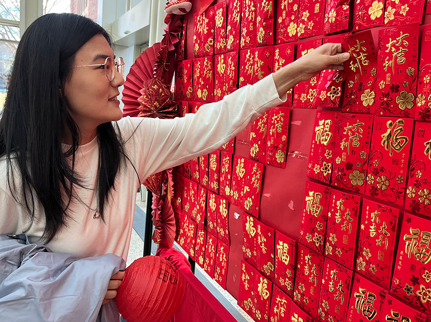 Olin student choosing a red envelope