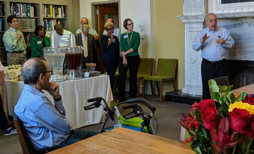 Former Dean Stuart Greenbaum offers his tribute to Ron Allen during a retirement reception at Kopolow Library in Simon Hall on October 12.